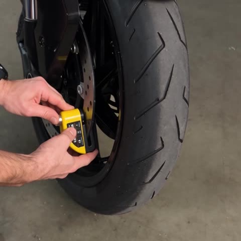 Hands clamping the LoudLock onto a brake disc